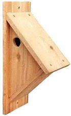 a wooden birdhouse with two holes in it