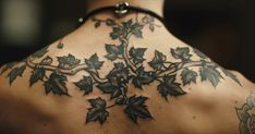 the back of a woman's neck with leaves on it