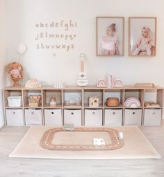 a baby's room with toys and pictures on the wall