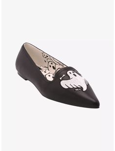 a pair of black shoes with white skulls on the front and bottom, one shoe has a