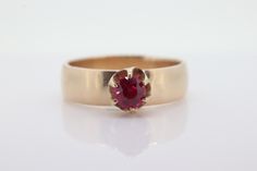 Amazing find. Stunning Gold solitaire ring with a round claw set ruby. Condition: No visible wear. Ruby is in excellent condition. Unmarked tests 10k gold. Details: 10k Yellow Gold - Ring total weight 5.0 grams.  Ruby measuring 4.5mm round. 5.5mm wide shank size 18 This is a unique ring you will not find anywhere else. Vintage, estimated to be 1920s. Classic Solitaire Ruby Promise Ring, Classic Solitaire Ruby Ring For Promise, Classic Promise Ruby Solitaire Ring, Heirloom Ruby Solitaire Ring, Heirloom 14k Gold Solitaire Ruby Ring, Heirloom Solitaire Ruby Ring In Round Cut, Formal Solitaire Ruby Ring With Round Cut, Ruby Ring With Center Stone In 14k Gold, Round Ruby Birthstone Ring Stamped 14k