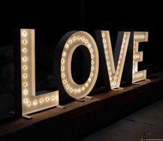 the word love is lit up with light bulbs