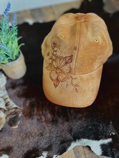 A one-of-a-kind hat, with a unique design hand-burned by our talented artist. Embracing the art of pyrography, this baseball cap is a must-have accessory for any cowboy or cowgirl. Includes an adjustable back strap. We are happy to take custom orders. Please reach out with the design you are looking for!                                                                                          Bundle and save! Do you have a friend or family member who also wants an awesome unique hat? Do you have Distressed Brown Baseball Cap, Artistic Snapback Hat, One Size Fits Most, Artistic Snapback Hat One Size Fits Most, Artistic Adjustable Trucker Hat, Artistic Adjustable Baseball Cap, Hand Painted Snapback Hat, Hand Painted Adjustable Snapback Hat, Adjustable Hand Dyed Hat With Curved Brim, Hand Dyed Adjustable Hat With Curved Brim