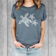 Women's Bella Tri-Blend relaxed unisex fit T-shirt with a Sea Turtle screen printed graphic design.  Super soft, stretchy, and comfy material.   Available with black or white ink! FIT: Follow the image size chart Unisex Fit - Runs Large - Long Length  Suggest sizing down if you prefer a more fitted look instead of relaxed -  Bella 3.8 oz  Super Soft hand and lightweight  -  Tri Blends:  50% Poly, 25%  Cotton, 25%  Rayon -  Does not shrink -  Hand screen printed to order in Oregon - Model is wearing a size small Fashion Fitted Style  http://etsy.me/2qjx3lC ♥ All of our tees are hand-printed to order in our shop in Portland Oregon! ♥ RETURNS & EXCHANGES We gladly accept exchanges and returns if not worn.   Please follow the chest measurement size guide for fit if you are unsure.  We custom p Pre-shrunk White Print Graphic Tee, Comfortable Fit Graphic Tee With Short Sleeves, Sublimation Print Crew Neck Graphic Tee, Graphic Tee With Sublimation Print And Crew Neck, Graphic Tee With Sublimation Print In Tri-blend Fabric, Graphic Tee With Sublimation Print In Relaxed Fit, Tri-blend Graphic Tee With Sublimation Print, White Print Screen Printed Short Sleeve Tops, Comfortable Graphic Print Crew Neck T-shirt