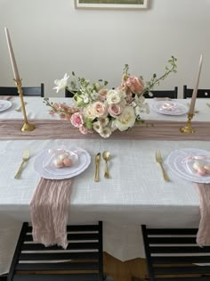 the table is set with pink and white flowers