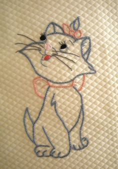 a close up of a cat embroidered onto a mattress with the word hello kitty on it