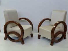 two white chairs sitting next to each other