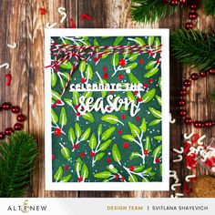 a christmas card with the words celebrate season on it, surrounded by evergreen branches and red berries