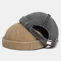 a hat that is sitting on top of a white surface and has a metal buckle around the visor