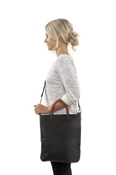 The slimline style of this crossbody bag is smart and casual. The adjustable crossbody strap keeps your hands free or remove the strap and carry by its two leather handles for a chic handbag look. Coated Canvas Crossbody Shoulder Bag With Leather Handles, Everyday Top Handle Shoulder Bag With Leather Handles, Chic Bag Strap With Leather Handles For Daily Use, Everyday Use Laptop Bag With Leather Top Handle, Everyday Laptop Bag With Adjustable Strap And Double Handle, Crossbody Shoulder Bag With Leather Trim For Work, Leather Trim Crossbody Shoulder Bag For Work, Chic Coated Canvas Shoulder Bag With Adjustable Strap, Chic Double Handle Bag Strap For Everyday Use