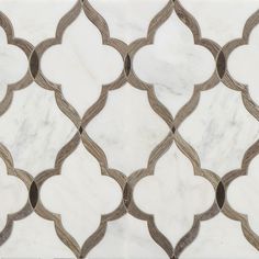 a white marble tile with an intricate design in the middle and brown trim around it