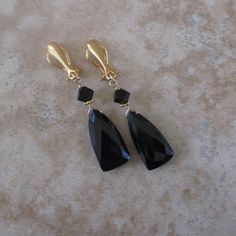 Black onyx clip-on earrings will never go out of style. You can dress up or down with them and mix or match them with almost any color. The quality stones and earring components create a lasting pair of black clip earrings. *Medium-sized, faceted black onyx stones: .75 inch long by .4 inch wide *Slim, 24k gold-plated, sterling-silver ear clips: .2 inch wide by .6 inch long *Approximate earring length: 1.8 inches Black Clip-on Earrings As Gift, Black Clip-on Earrings For Gift, Classic Black Clip-on Earrings For Evening, Classic Black Clip-on Earrings For Formal Occasions, Black Clip-on Jewelry For Formal Occasions, Classic Black Clip-on Earrings, Formal Black Clip-on Earrings, Black Clip-on Earrings For Formal Occasion, Ear Clips