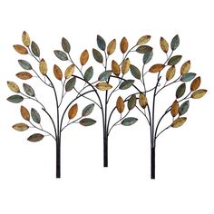 three metal trees with leaves on them are set against a white background, one is gold and the other is black