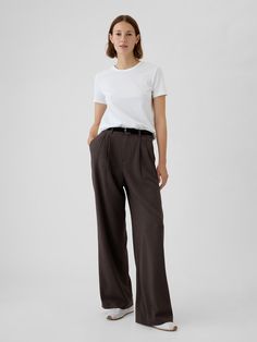 Soft, warm brushed twill trousers.  E-waist with concealed hook and bar closure, zip fly.  Front slant pockets, back welt pockets.  Pleating at front.  Fit: Classic.  An easy silhouette that fits close at the waist, and is relaxed through the hips and thigh.  Models wearing Gap Trousers Outfit Winter, Brown Trousers Outfit, Taupe Trousers, Cotton Trousers Women, Fw 2024, Fall Winter Capsule Wardrobe, Easy Silhouette, Work Fits, Brown Trousers