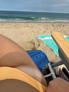 a person laying on top of a beach next to the ocean