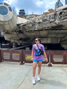 a woman standing in front of a star wars vehicle at disney's hollywood studios