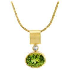 Discover the elegance of our Peridot Diamond Minimalist Pendant - an exquisite blend of radiant Pakistani peridot set in a luxurious satin 18K bezel, elevated with the dazzling twinkle of a brilliant diamond. This unique piece is meticulously crafted from 18k Royal yellow gold, a bespoke European alloy with a distinct cooler and refined tone, unlike the typical 18k gold found in the US. This unique gold variation bestows an additional layer of richness to our jewelry and harmonizes seamlessly with the vibrant green hues of the peridot gemstone. Peridot, a gemstone with a rich history dating back over 4000 years, is popular for its vibrant yellow-green color. As an August birthstone and a celebratory gem for the 15th wedding anniversary, this pendant is an ideal gift for those special momen 15th Wedding Anniversary, Royal Yellow, Minimalist Pendant, Blue Topaz Stone, Jewelry Accessories Ideas, Peridot Gemstone, August Birth Stone, Pendant Design, Brilliant Diamond