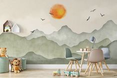 a child's room with mountains painted on the wall and toys in the foreground