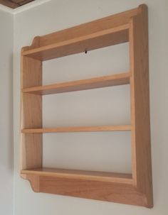 a wooden shelf mounted to the side of a wall