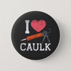 i love caulk pinback button with scissors and heart on black back ground