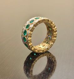 DeKara Designs Collection Metal- 18K Yellow Gold, .750. Stones- 17 Genuine Round Emeralds 1.90 Carats, 102 Round Diamonds F-G Color VS1 Clarity 0.42 Carats. Entirely Handmade 18K Yellow Gold Eternity Diamond Round Emerald Engagement Band. This band is extremely elegant featuring round fiery, and beautiful green emeralds that are all professionally burnish set individually with amazing bead work surrounding each stone. There are 51 professionally pave set round diamonds on the top and bottom of b Luxury Gold Bridal Sets With Cubic Zirconia, Luxury Gold Cubic Zirconia Bridal Sets, Luxury Gold Diamond-cut Bridal Sets, Luxury Gold Diamond Cut Bridal Sets, Luxury Bridal Sets With Diamond Accents, Round Shape, Emerald Wedding Jewelry With Pave Setting, Luxury Diamond Bridal Sets, Luxury Gold Bridal Sets With Diamonds, Luxury Yellow Gold Bridal Sets For Wedding