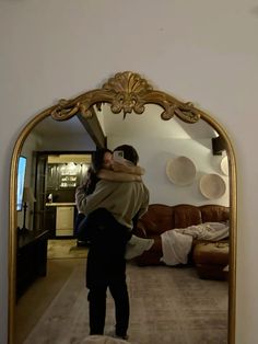 a woman taking a selfie in front of a mirror with the reflection of herself