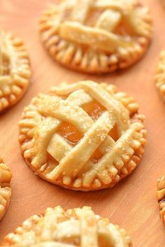 many small pies are arranged on a wooden surface