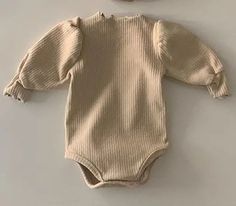 Wrap your little one in cozy comfort with our Long-Sleeved Ribbed Onesie. Made from soft and breathable cotton, this unisex onesie is perfect for babies aged 6 to 24 months. The O-neck collar and solid pattern add a touch of style, while the long sleeves provide extra warmth during the winter season. Crafted with your baby's comfort in mind, this onesie is a must-have for any parent. 🌟👶 #BabyEssentials #CozyComfort Specifications: Material: Cotton Gender: Unisex Item Type: Onesie Age Range: 6– Cute Soft Long Sleeve Onesie, Cute Long Sleeve Soft Onesie, Cream Long Sleeve Onesie For Loungewear, Solid Cotton Long Sleeve Bodysuit, Long Sleeve Solid Cotton Bodysuit, Solid Long Sleeve Cotton Bodysuit, Solid Color Cotton Ribbed Onesie, Cotton Ribbed Onesie In Solid Color, Ribbed Cotton Onesie