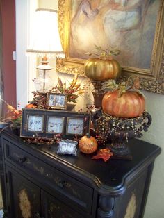 there is a black table with candles and pumpkins on it