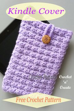 the crochet kindle cover has a button on it and is next to a cell phone