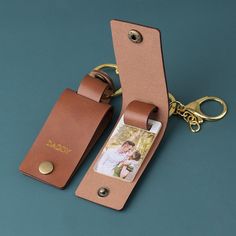 a leather keychain with a personalized photo on the front and back side