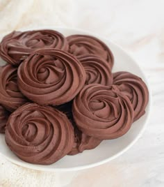 some chocolate cupcakes on a white plate