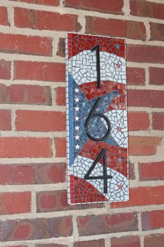 a red white and blue brick wall with a number sign on it's side