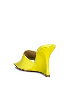 Find BOTTEGA VENETA Stretch Mule Wedges In Yellow on Editorialist. Bottega Veneta Stretch Mule Wedges in Yellow Leather upper with rubber-injected leather sole. Made in Italy. Leather lining with debossed Bottega Veneta logo detail. Square toe. Approx 89mm/ 3.5 inch wedge. BOTT-WZ318. 690024 VBSF0 7278. About the designer: Bottega Veneta – inspiring individuality with innovative craftmanship since 1966. Creativity lies at the heart of all that we do. Born in Vicenza the house is rooted in Italian culture yet maintains a truly global outlook. An inclusive brand with exclusive products Bottega Veneta is as much of a feeling as it is an aesthetic. Fitted Leather Sandals With Sculpted Heel, Yellow Leather Sandals With Padded Heel, Luxury Fitted Sandals With Deep Heel Cup, Fitted Leather Sandals With Padded Heel, Yellow Leather Heels With Sculpted Heel, Yellow Leather Slip-on Heels, Designer Leather Wedge Heels, Designer Yellow Leather Heels, Yellow Leather Sandals With Pointed Toe