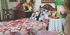 a bedroom with a bed covered in colorful quilts