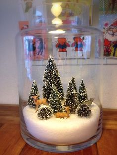 a snow globe with christmas trees in it