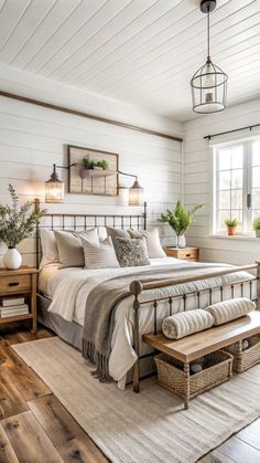 a bedroom with white walls and wood flooring is decorated in neutral tones, including the bed