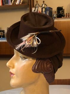 Unique and rare this vintage women's hat, in the shape of a small cylinder, made of felt and jersey-like knitted fabric, signed Ditta Franceschini Firenze. Brown colored, with a decoration only on one side of nylon threads in pastel colors A high band of jersey that wraps around the nape of the neck or the hairstyle allows to fix the hat. A unique and rare collector's item, signed, in perfect vintage condition. Jersey Hat, History Fashion, Costume Hats, Rare Antique, Hat Fashion, Costume Accessories, Brown Color, Hats For Women, Headpiece