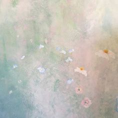 an abstract painting with daisies and other flowers on the wall in front of it