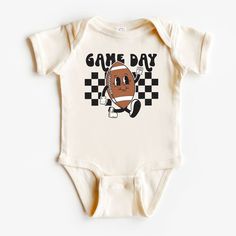 The perfect bodysuit for your perfect baby! These short sleeve bodysuits have 3 snap closure and double needle ribbed binding on neck, shoulders, sleeves, and leg openings. Machine wash cold, inside out. Air dry or tumble dry low. Baby Super Bowl Outfit, Casual Onesie With Letter Print For Game Day, White Short Sleeve Onesie For Game Day, House Divided Baby Shirt, Newborn Onsies, Game Day Onesie, Football Onesie, Macbook Air Cover, One Piece Clothing