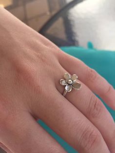 A gorgeous, highly-crafted, sterling silver Daisy Ring. This is a romantic ring with a delicate Daisy/ Plumaria flower on a Sterling silver band. A truly elegant  ring.The Plumaria a flower of ancient India known for its enchanting fragrance, in Hawaii it symbolizes Positivity and to celebrate special occasions. We use the purest 925 sterling silver in all of our designs.  We strive to provide you with a meticulously crafted piece of beautiful jewelry. All of our rings come with a high shine fin Sterling Silver Jewelry With 3d Flower Design, Dainty Flower Ring For Anniversary, Dainty Flower Ring With Flower Charm, Flower Shaped Birthstone Promise Ring, Sterling Silver Jewelry With 3d Flowers In Silver, Dainty Daisy Silver Jewelry, Dainty White Gold Sterling Silver Flower Ring, Dainty White Gold Flower Ring In Sterling Silver, Delicate Sterling Silver Flower Ring As Gift