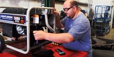 a man working on a machine in a shop