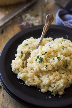 a close up of a plate of food with rice and parsley on it,