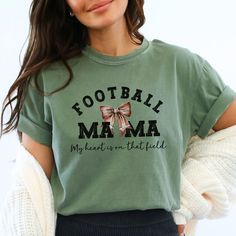 Football Mama T-shirt, Sports Mom Coquette Tee, My Heart is on that field, Football Season, Game Day Vibes, Oversized Comfort Colors® Tee https://modestglowboutique.etsy.com/listing/1617977632 for more great shirts/gift ideas! This listing is for one garment dyed, relaxed fit, adult tee with the design as seen in the listing photos. Keep in mind that shirt and design colors may vary slightly depending on your computer screen settings or the shirt color you chose.  HOW TO ORDER: 1. Review all photos as well as the size chart photo to determine which size works best for you. The pre-shrunk fabric ensures a consistently great fit. 2. Select your desired shirt size and color (the colors in the drop-down menu are the only colors available in this design). 3. Select the desired quantity. 4. Clic Green T-shirt With Letter Print For Football Season, Fall Sports T-shirt With Letter Print, Green Sports Fan Tops With Letter Print, Sports Fan Green Tops With Letter Print, Green Tops With Letter Print For Game Day, Green Letter Print Tops For Game Day, Fall T-shirt With Text Print For Sports Events, Green Letter Print Tops For Football Season, Field Football