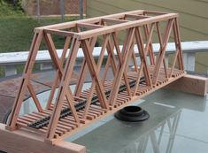 a wooden bridge sitting on top of a glass table