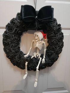 a wreath with a skeleton wearing a santa hat