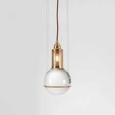 a white and gold light hanging from a ceiling