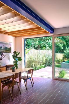 a dining room with sliding glass doors leading to an outdoor swimming pool and hot tub