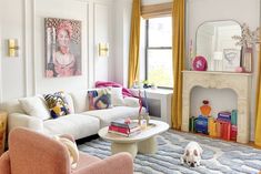 a living room filled with furniture and a dog on the floor in front of a fire place