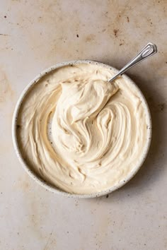 a bowl filled with cream sitting on top of a counter